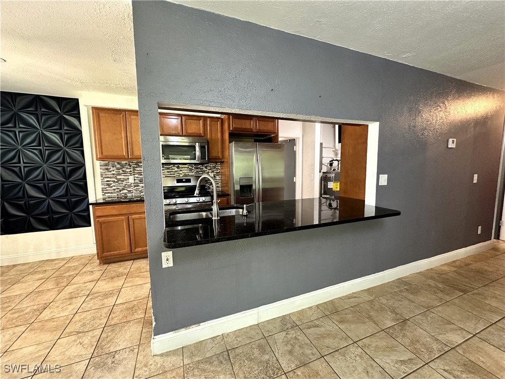 818 Sheldon Avenue Lehigh Acres, FL 33936 - Photo 15 of 43 a view of a living room with a wooden floor
