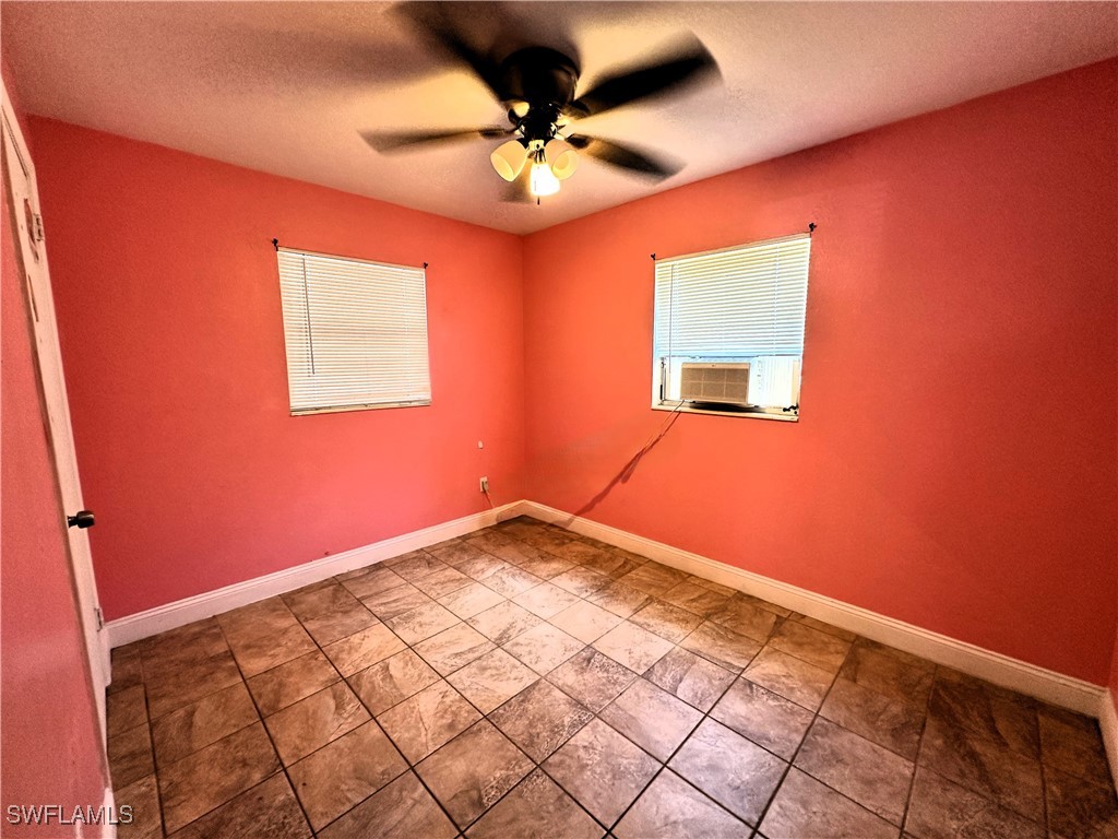 818 Sheldon Avenue Lehigh Acres, FL 33936 - Photo 18 of 43 a view of an empty room and a window