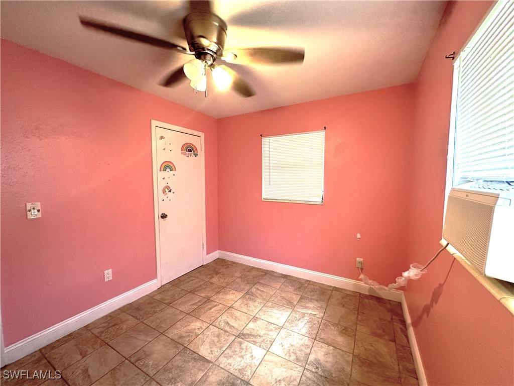 818 Sheldon Avenue Lehigh Acres, FL 33936 - Photo 19 of 43 a view of a livingroom with a chandelier fan and a window