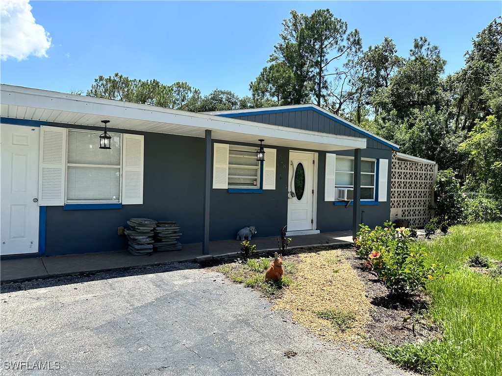 818 Sheldon Avenue Lehigh Acres, FL 33936 - Photo 2 of 43 a house view with a outdoor space
