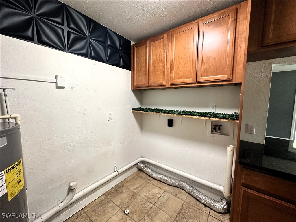 818 Sheldon Avenue Lehigh Acres, FL 33936 - Photo 24 of 43 a view of a refrigerator with wooden floor