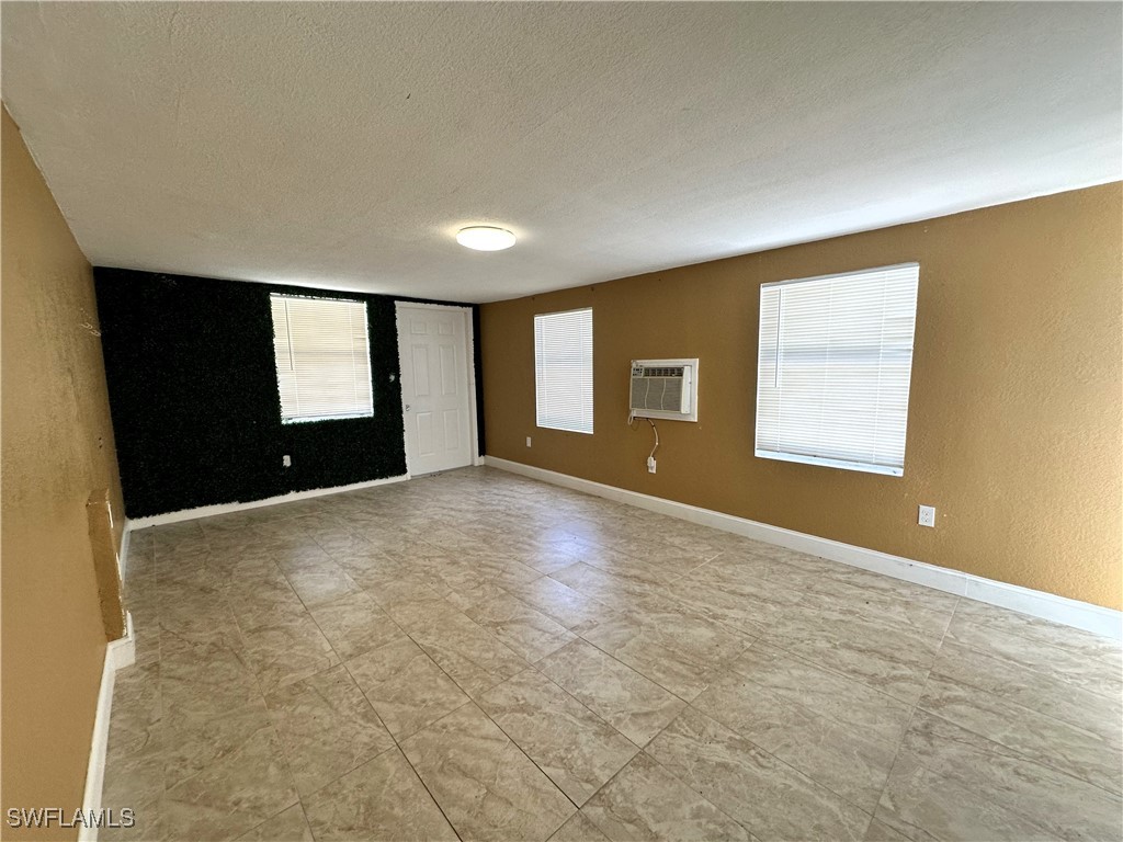 818 Sheldon Avenue Lehigh Acres, FL 33936 - Photo 26 of 43 a view of an empty room with a window