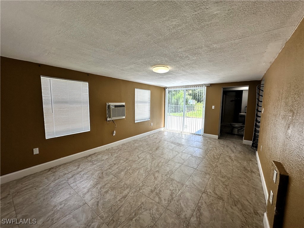 818 Sheldon Avenue Lehigh Acres, FL 33936 - Photo 27 of 43 a view of an empty room with a window