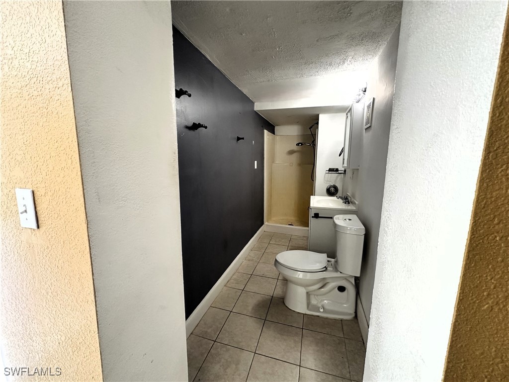 818 Sheldon Avenue Lehigh Acres, FL 33936 - Photo 28 of 43 a bathroom with a toilet and a shower
