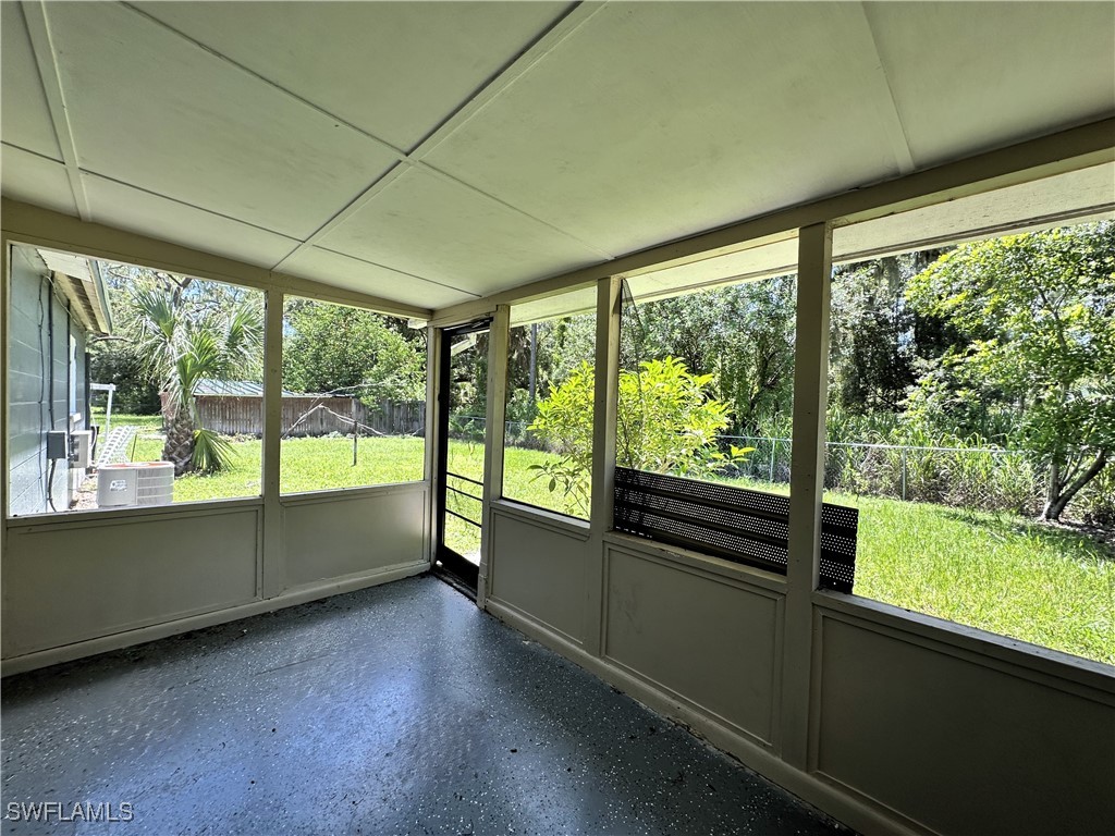 818 Sheldon Avenue Lehigh Acres, FL 33936 - Photo 29 of 43 a view of an empty room with wooden floor and a outdoor space