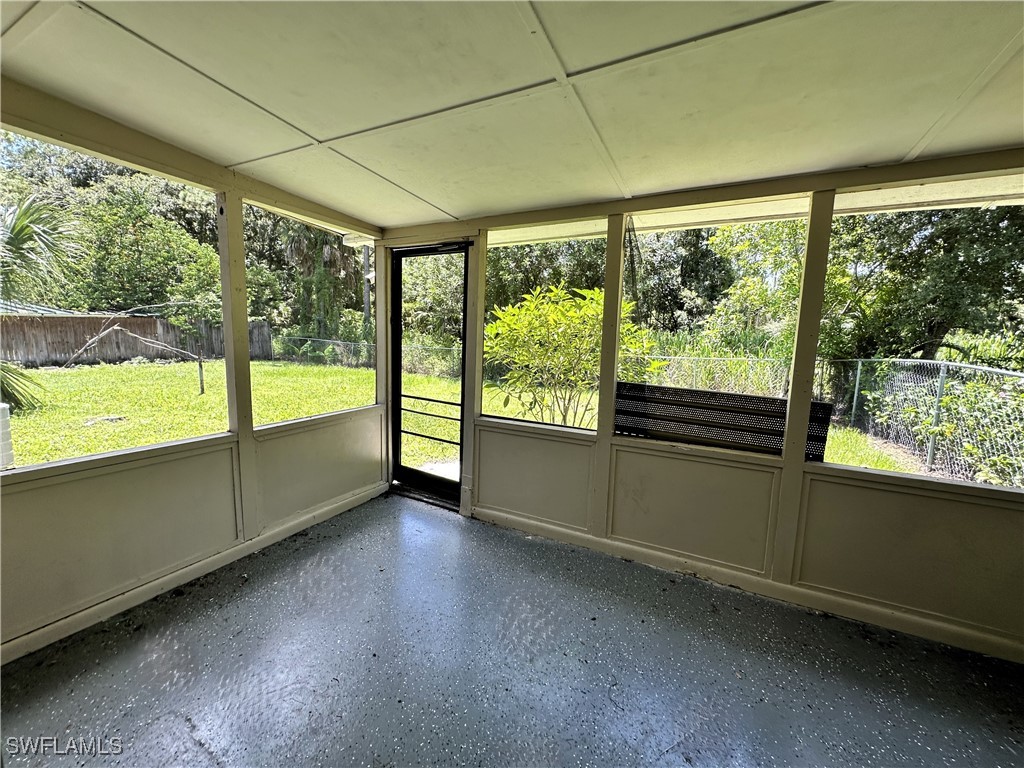 818 Sheldon Avenue Lehigh Acres, FL 33936 - Photo 30 of 43 wooden floor in an empty room with a large window
