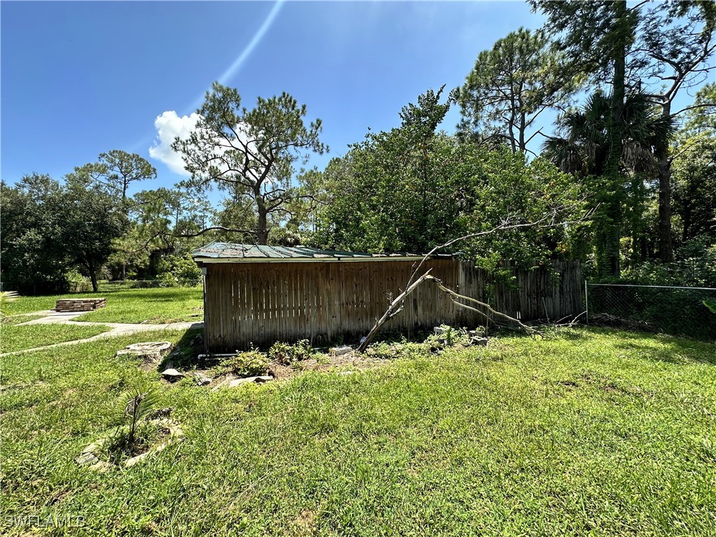 818 Sheldon Avenue Lehigh Acres, FL 33936 - Photo 33 of 43 a backyard of a house with lots of green space