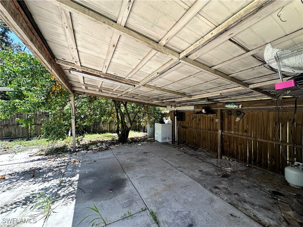 818 Sheldon Avenue Lehigh Acres, FL 33936 - Photo 34 of 43 a view of a garage with wooden walls
