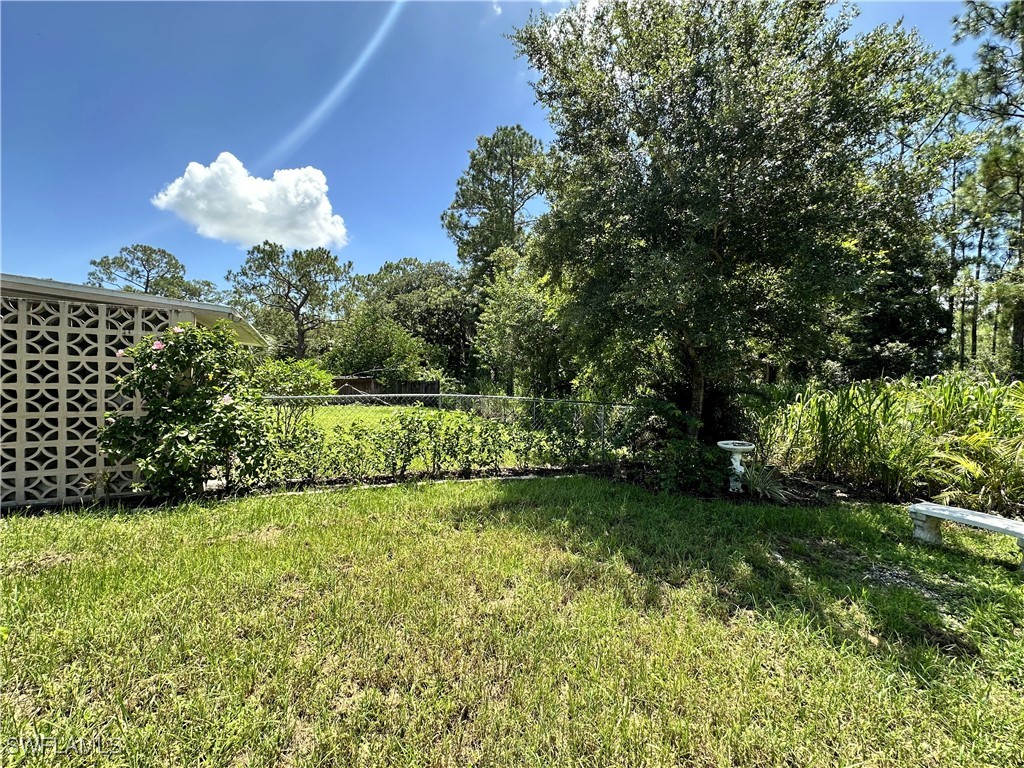 818 Sheldon Avenue Lehigh Acres, FL 33936 - Photo 39 of 43 a view of a yard with a house