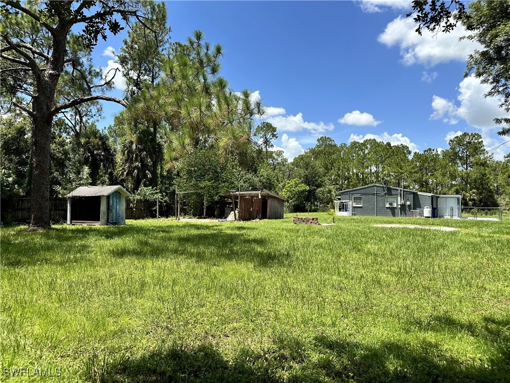 818 Sheldon Avenue Lehigh Acres, FL 33936 - Photo 43 of 43 a view of a house with a backyard