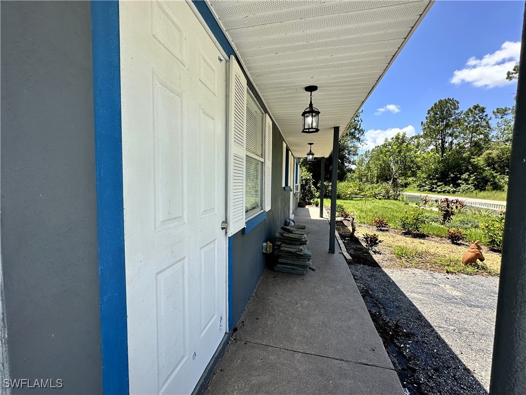 818 Sheldon Avenue Lehigh Acres, FL 33936 - Photo 5 of 43 a view of a pathway of a house with a yard