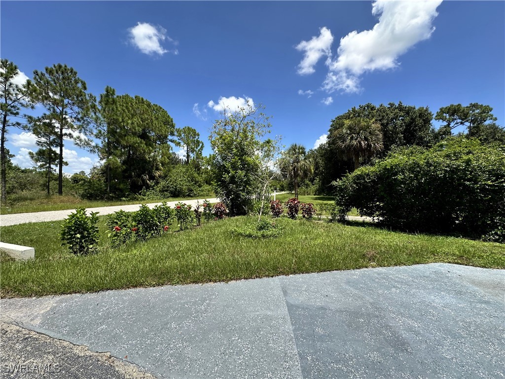 818 Sheldon Avenue Lehigh Acres, FL 33936 - Photo 6 of 43 a view of a house with a big yard