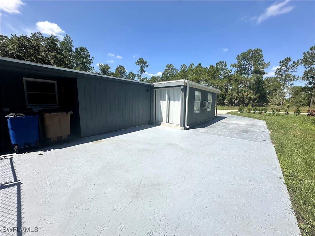 818 Sheldon Avenue Lehigh Acres, FL 33936 - Photo 8 of 43 a front view of a house with a yard
