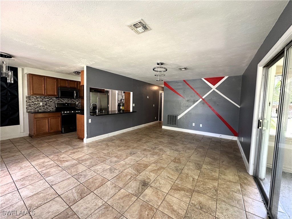 818 Sheldon Avenue Lehigh Acres, FL 33936 - Photo 9 of 43 a view of an empty room