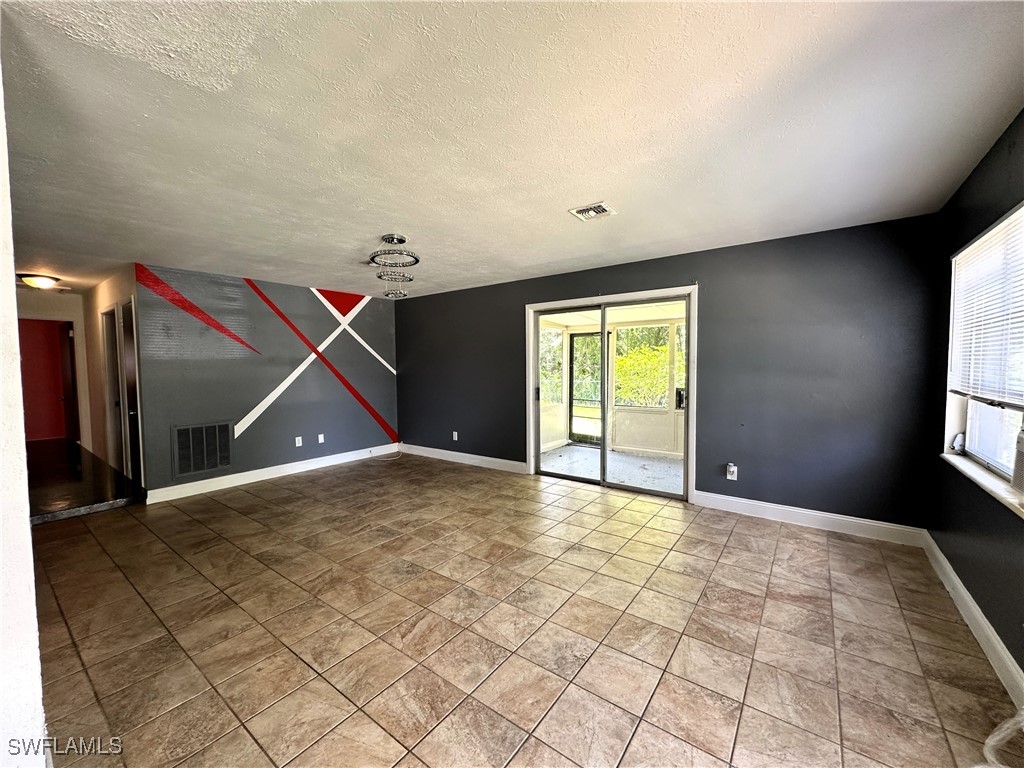 818 Sheldon Avenue Lehigh Acres, FL 33936 - Photo 10 of 43 a view of an empty room with a window
