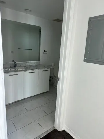 a room with a sink and a mirror