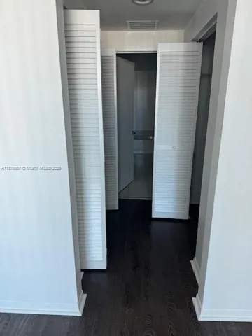 an entryway with wooden floor and a window