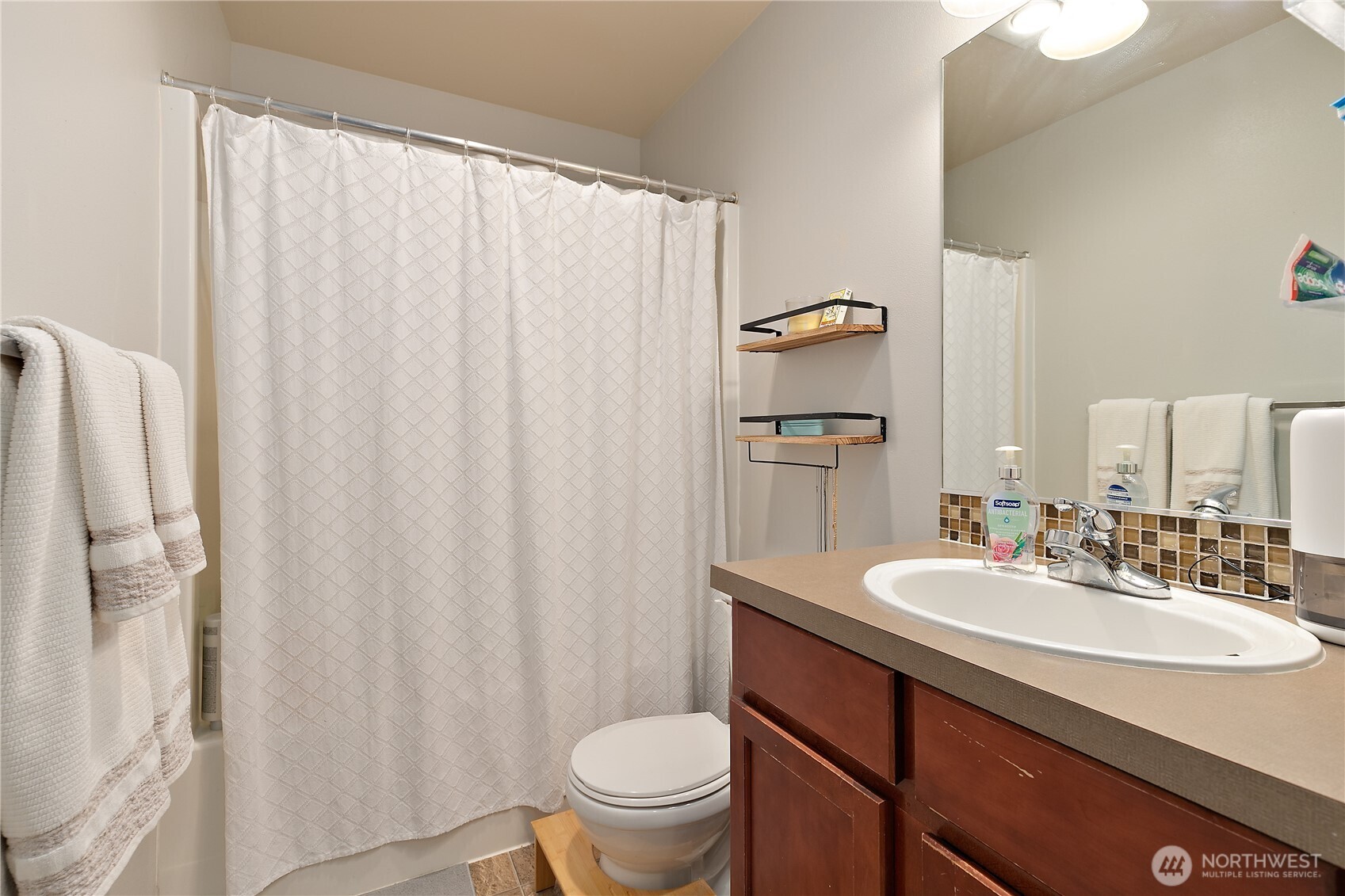 6600 Indiana Street Southeast Lacey, WA 98513 - Photo 17 of 21 a bathroom with a sink a toilet and shower curtain