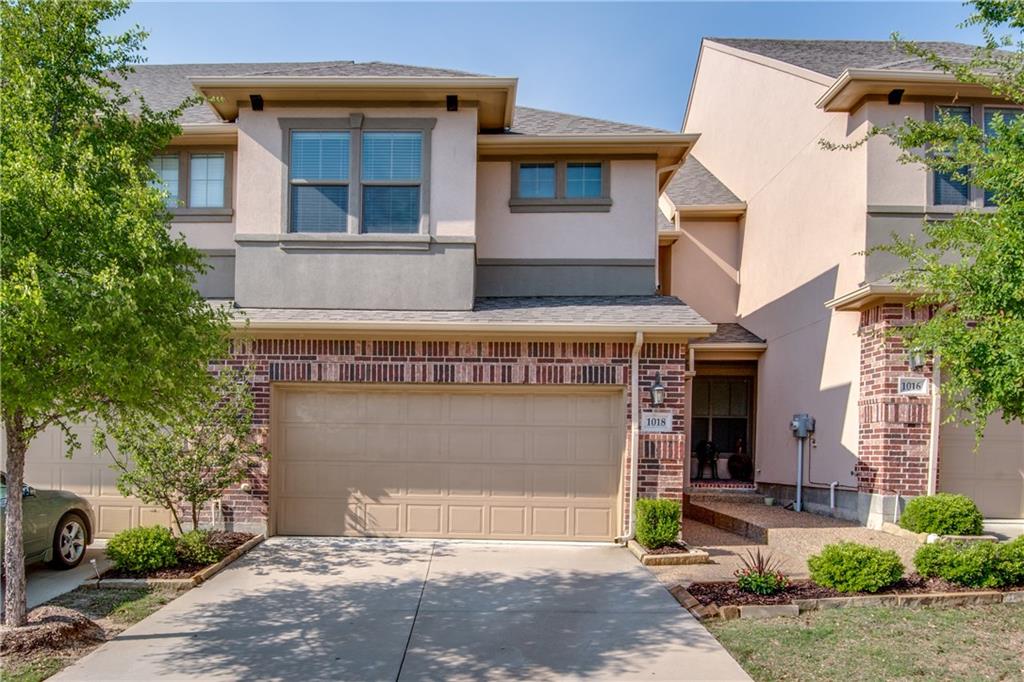 a front view of a building with garage