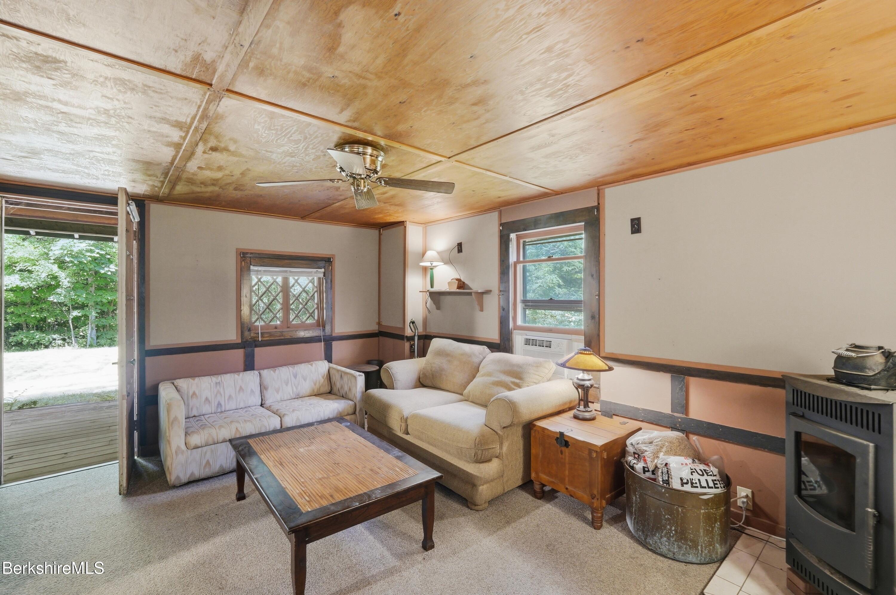 68 Curtin Road Peru, MA 01235 - Photo 26 of 38 a living room with furniture a ceiling fan and a window