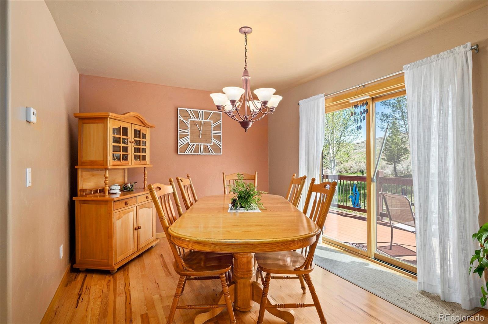 290 Village Road Granby, CO 80446 - Photo 13 of 45 a dining room with furniture a chandelier and wooden floor