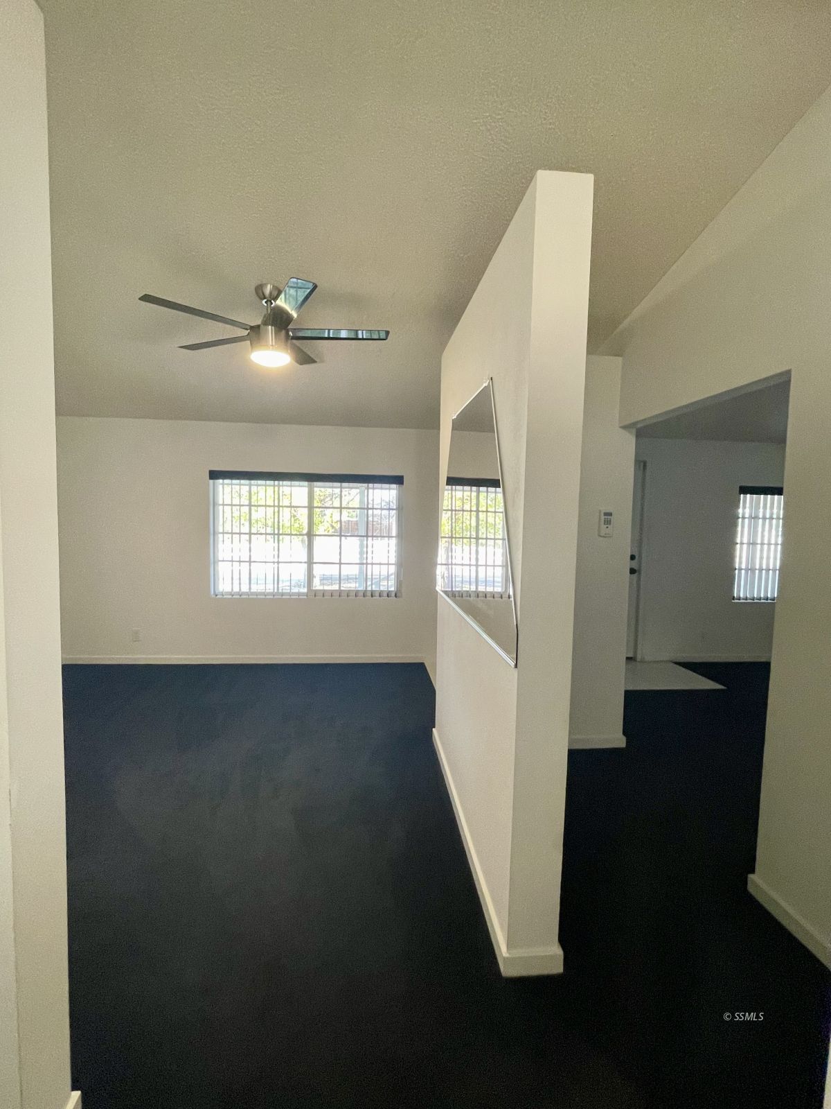 1449 Dunes Street Ridgecrest, CA 93555 - Photo 15 of 50 a view of an empty room with wooden floor and a window