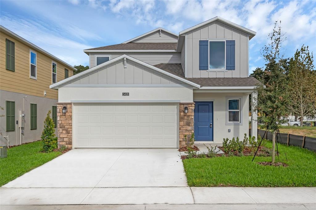 a front view of a house with a yard and garage