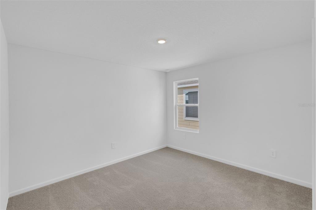 5428 Meadow Walk Drive Davenport, FL 33837 - Photo 19 of 24 a view of an empty room with a window