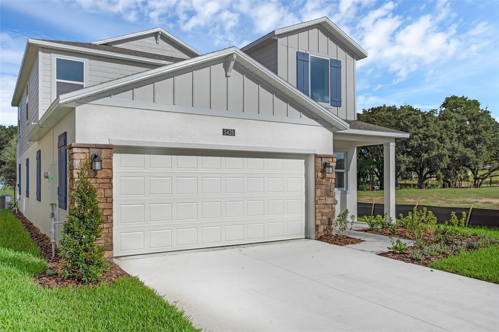 5428 Meadow Walk Drive Davenport, FL 33837 - Photo 2 of 24 a front view of a house with garden