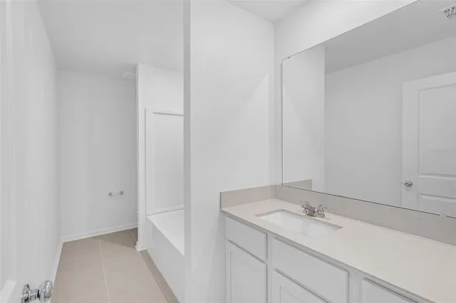 a bathroom with a sink and vanity