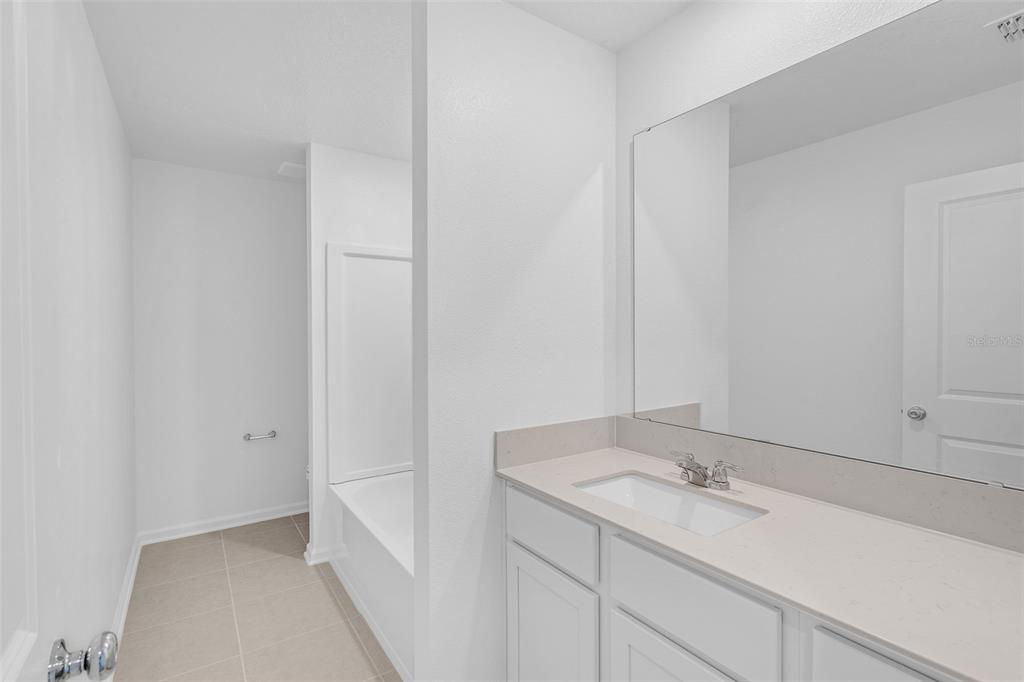 5428 Meadow Walk Drive Davenport, FL 33837 - Photo 22 of 24 a bathroom with a sink and vanity