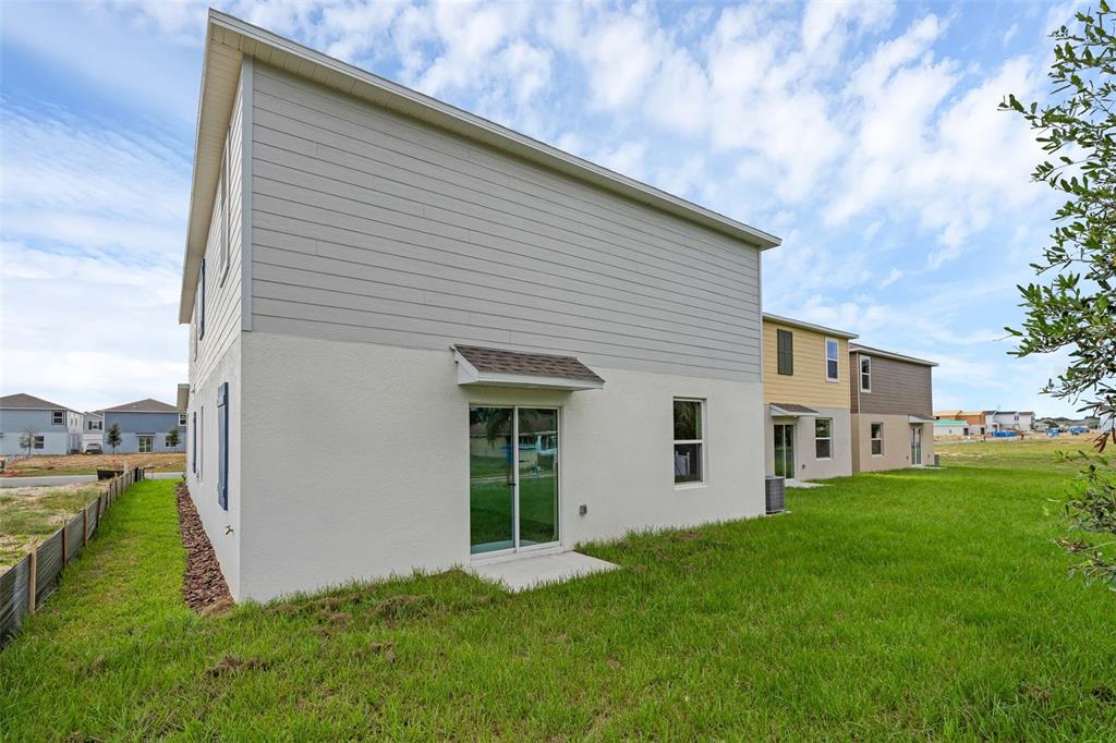 5428 Meadow Walk Drive Davenport, FL 33837 - Photo 23 of 24 a view of an house with backyard space and garden