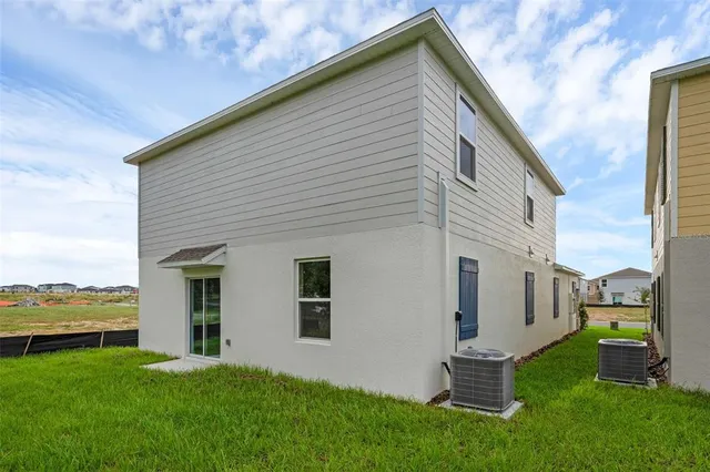 a backyard of a house with table and chairs