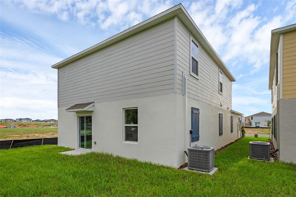 5428 Meadow Walk Drive Davenport, FL 33837 - Photo 24 of 24 a backyard of a house with table and chairs
