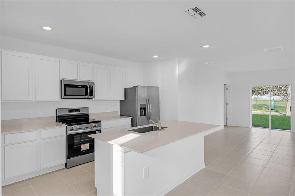 5428 Meadow Walk Drive Davenport, FL 33837 - Photo 8 of 24 a kitchen that has a sink and a stove top oven