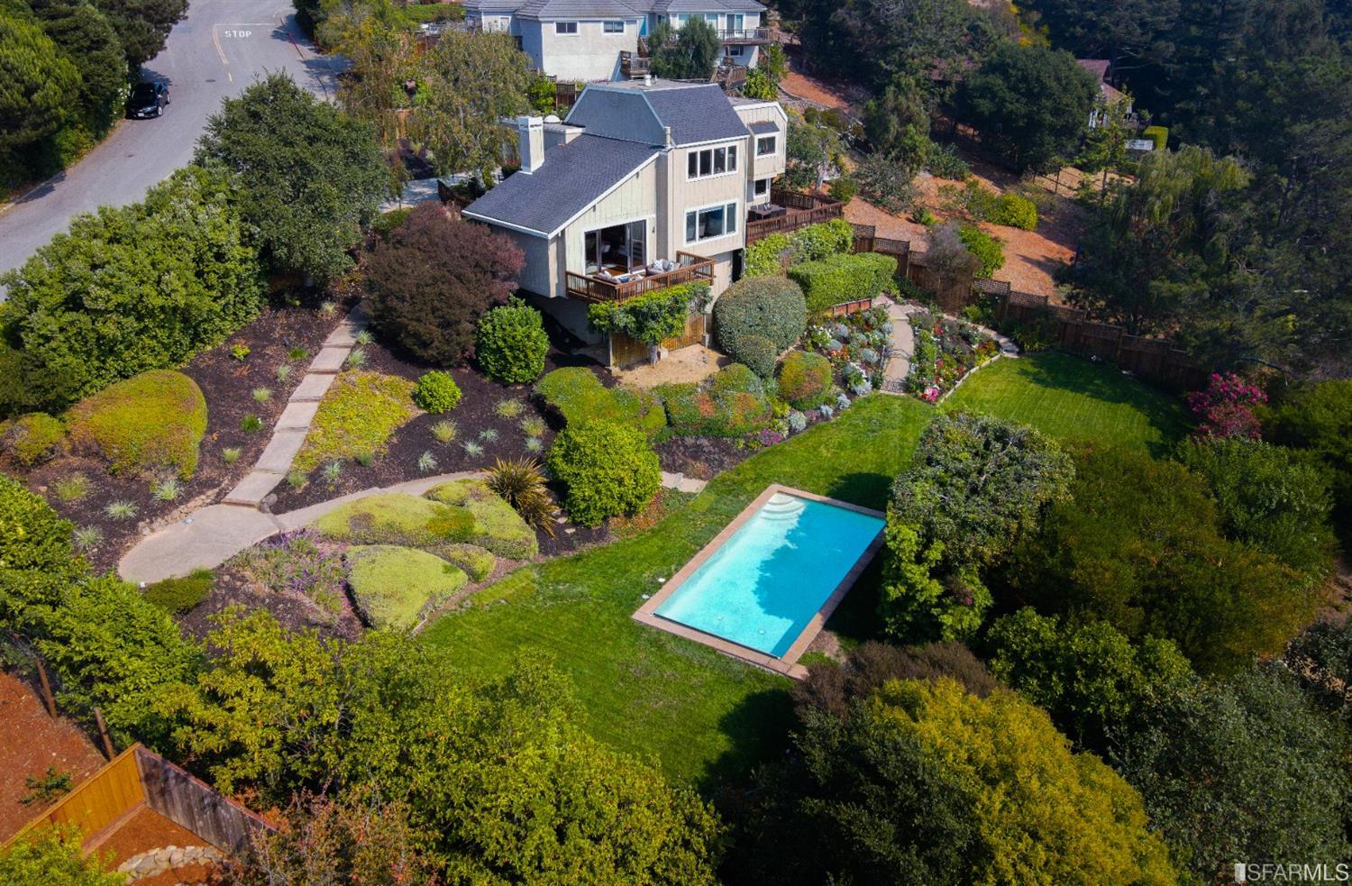 an aerial view of residential house with swimming pool and outdoor space