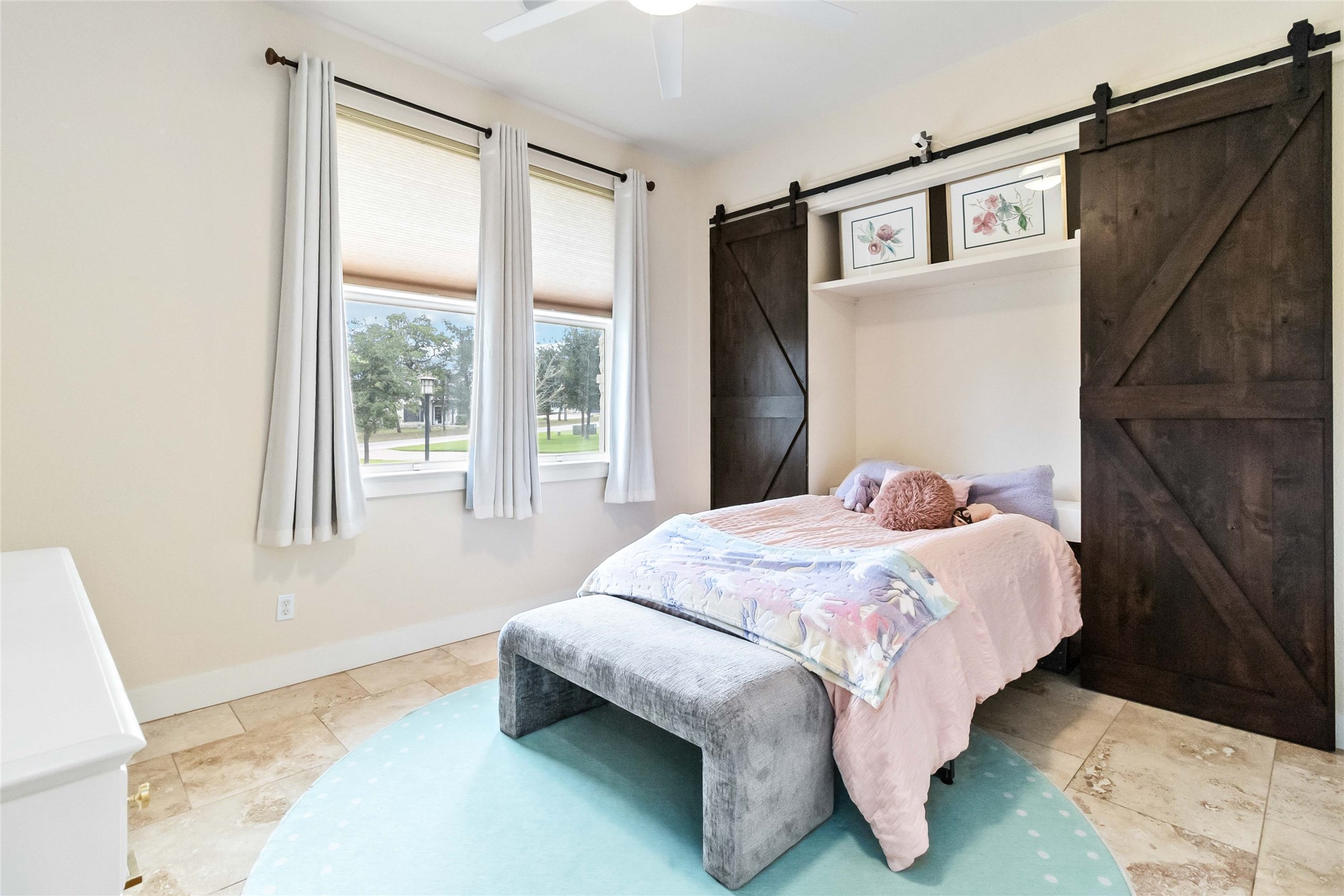 129 Powder Horn Road Bastrop, TX 78602 - Photo 17 of 27 Bedroom featuring a barn door and ceiling fan