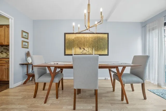 a kitchen with white cabinets and sink