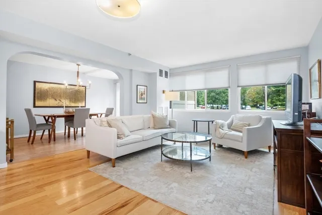 a view of a dining room with furniture and a large window