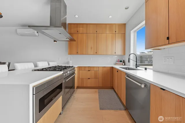 a kitchen with a sink stove and cabinets