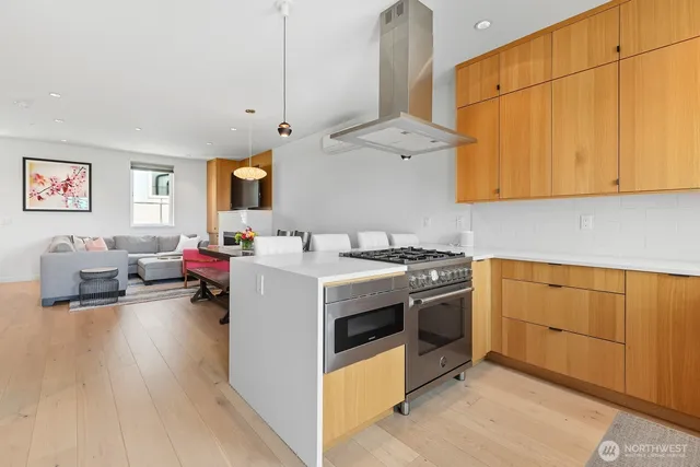 a kitchen with stainless steel appliances granite countertop a stove and a white cabinets