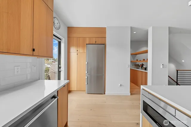a kitchen with stainless steel appliances a refrigerator and a stove