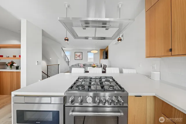a stove top oven sitting inside of a kitchen
