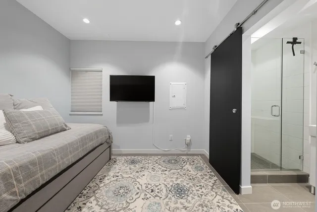 a bedroom with a bed and a television