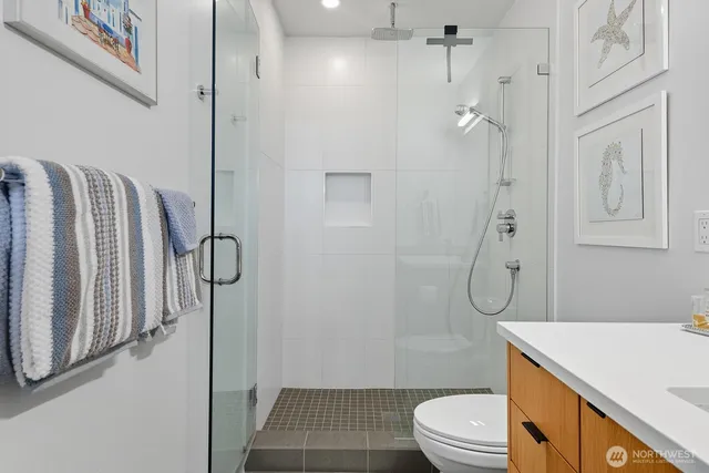 a bathroom with a granite countertop sink toilet and shower