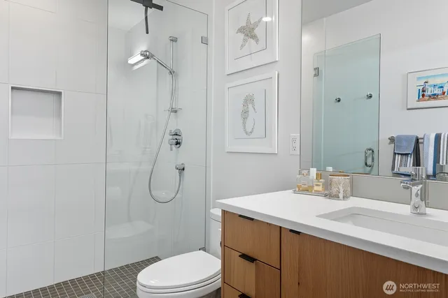 a bathroom with a granite countertop sink toilet and shower