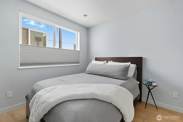 a bed sitting in a bedroom next to a window