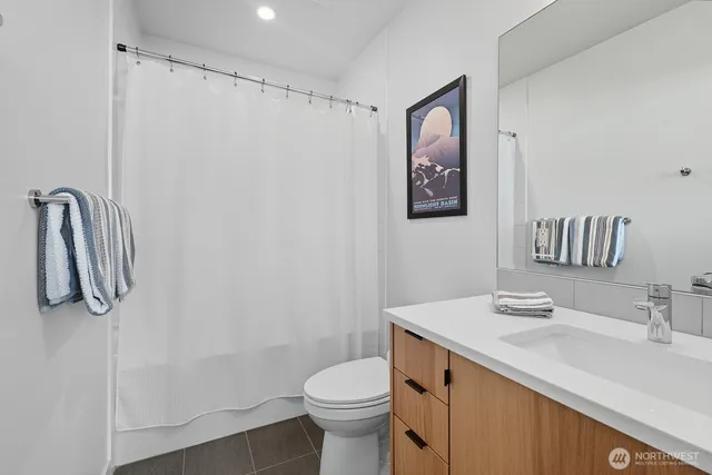 a bathroom with a sink vanity and toilet