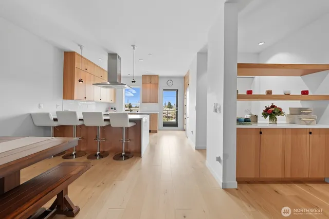 a room with stainless steel appliances kitchen island granite countertop a sink and cabinets