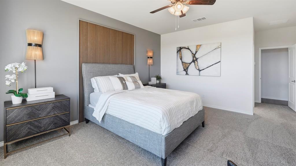 4197 Waldron Trail Forney, TX 75126 - Photo 17 of 25 Bedroom featuring textured wood wall paneling, a ceiling fan with integrated lighting, and soft gray carpeting